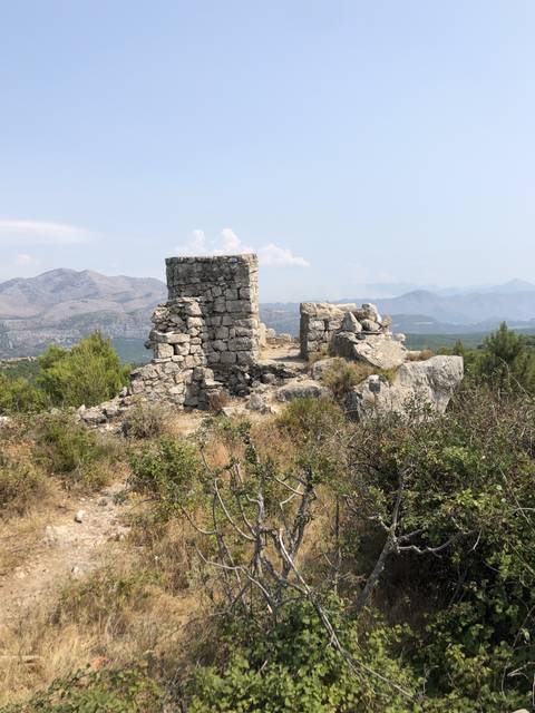       Rocky ruins on a hillside.
  