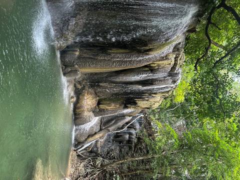 Waterfall cascading down rocky cliffs.