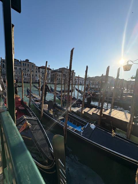       Gondolas on a canal in Venice.
  