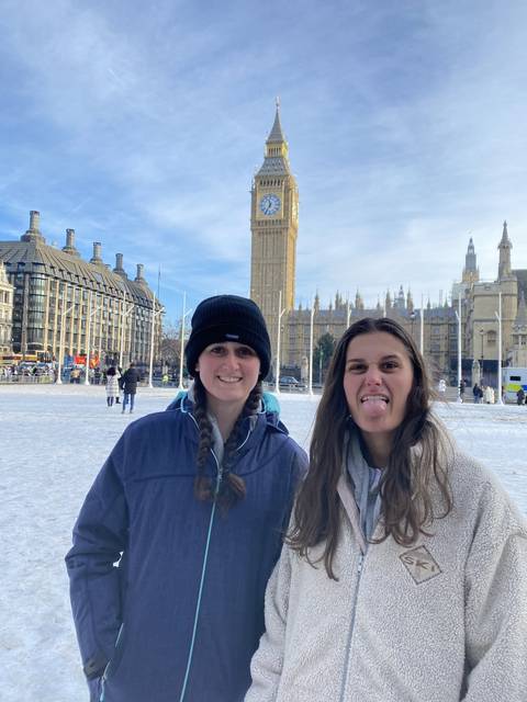       Two people smiling with a famous clock tower in the background.
  