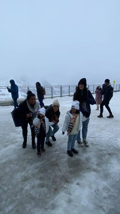 Group of people standing on an icy surface.