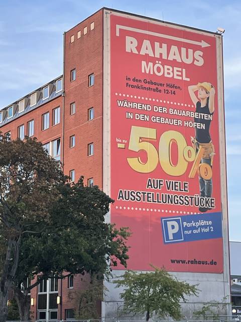 An advertisement on the side of a building.