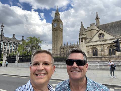 Two men smiling with Big Ben in the background.