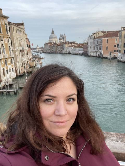       Person with Venice Grand Canal in the background.
  