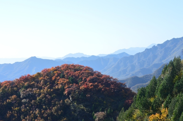 Mountain range with colorful autumn foliage.