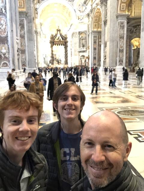 Family posing inside a grand cathedral or palace.