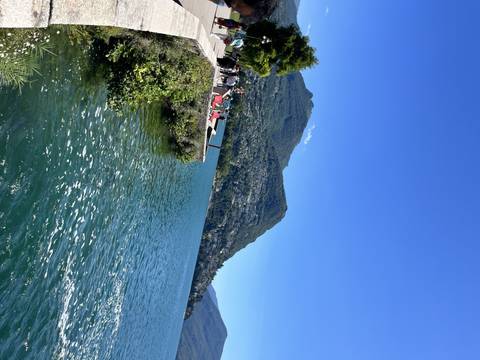       Waterfront view with mountains and a town.
  