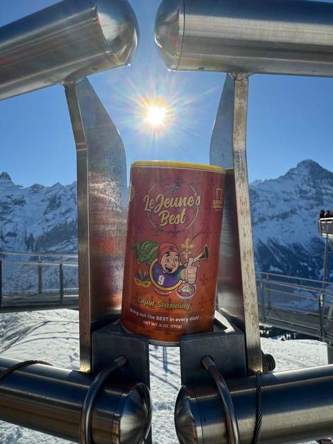 A can of LeJeune's Best hot sauce with sun in the background.