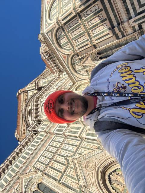 Person upside down in front of a cathedral.