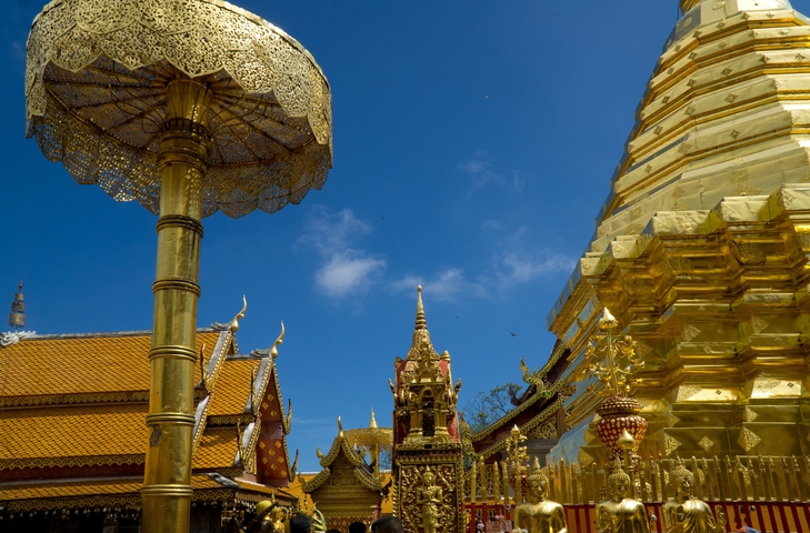Golden temple structures against a clear blue sky.