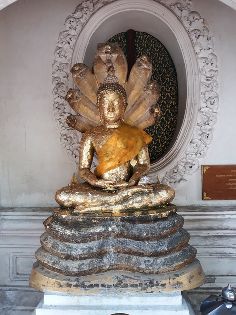 A Buddha statue with golden coverings in a temple.