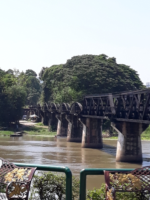Historic bridge over a river surrounded by trees.
