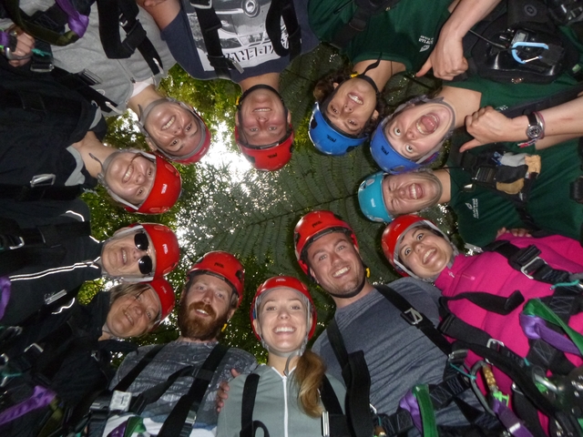 Group of people in helmets gathered in a circle.