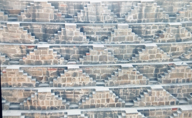       Close-up of a stepwell with patterned stone stairs.
  