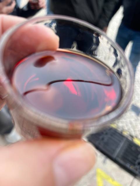       A glass with a beverage and a straw.
  