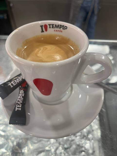       A cup of coffee on a saucer.
  