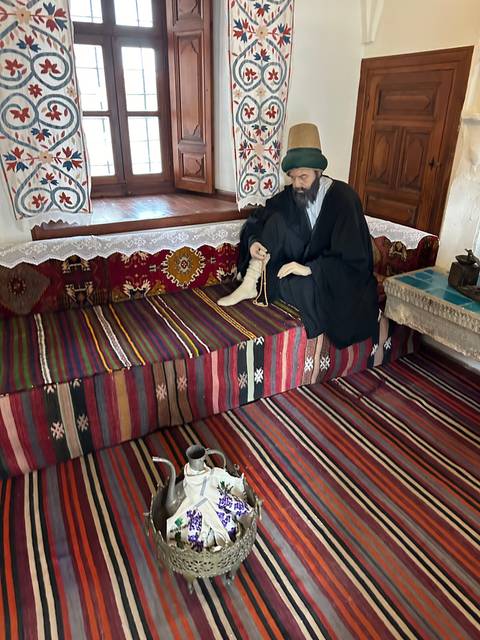       Person relaxing on a colorful patterned carpet indoors.
  