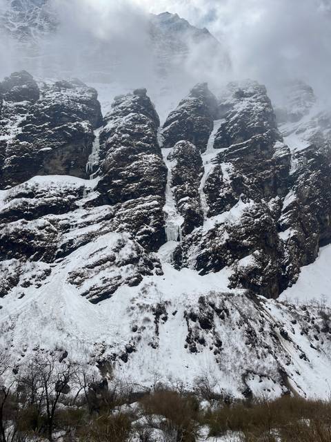 Snow-covered rocky mountainside.