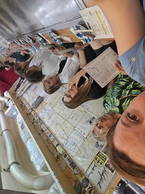       Group of people sitting in a restaurant.
  