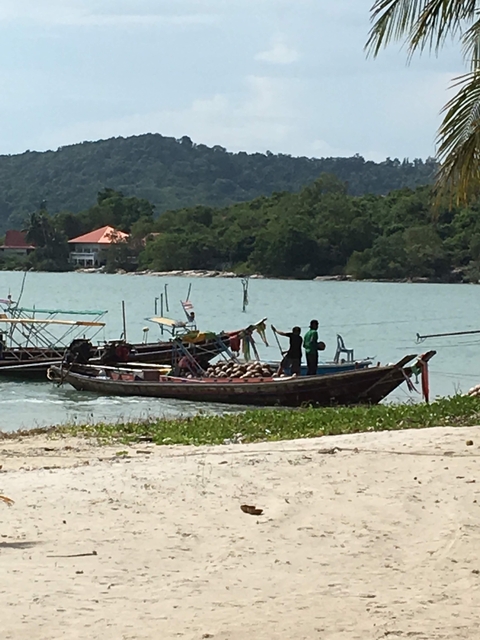      Two people on a boat in the sea.
  