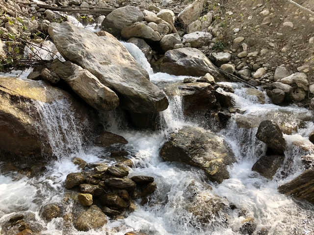       Water flowing through rocks, forming small waterfalls.
  