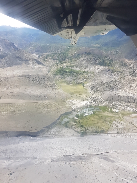 Aerial view of mixed terrains including fields and barren land.