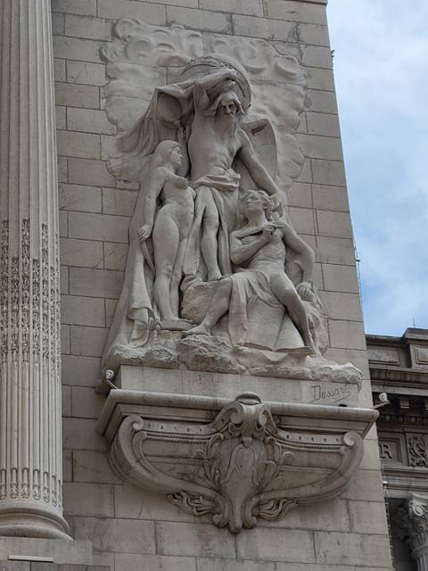       Stone sculpture on a building facade.
  