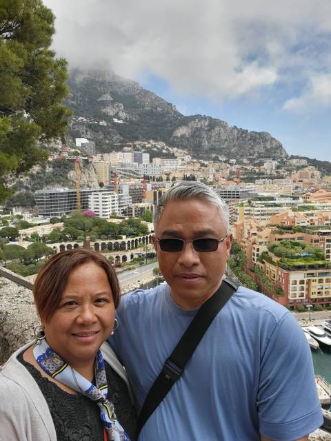       Couple with cityscape and mountains behind.
  