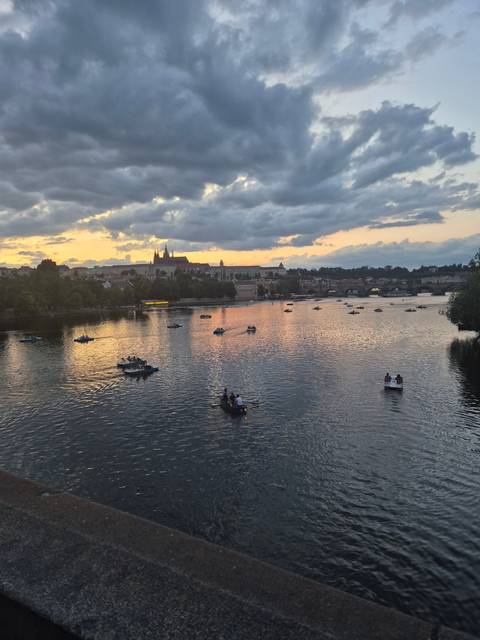       Row boats on a river during sunset.
  