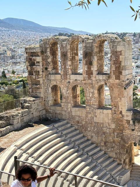       Ancient amphitheater with city view.
  