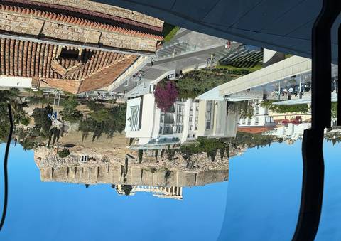       Modern buildings with ancient ruins.
  