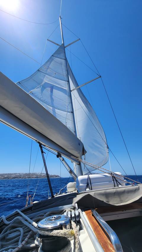       Close-up of a sail and mast on a sailing boat.
  