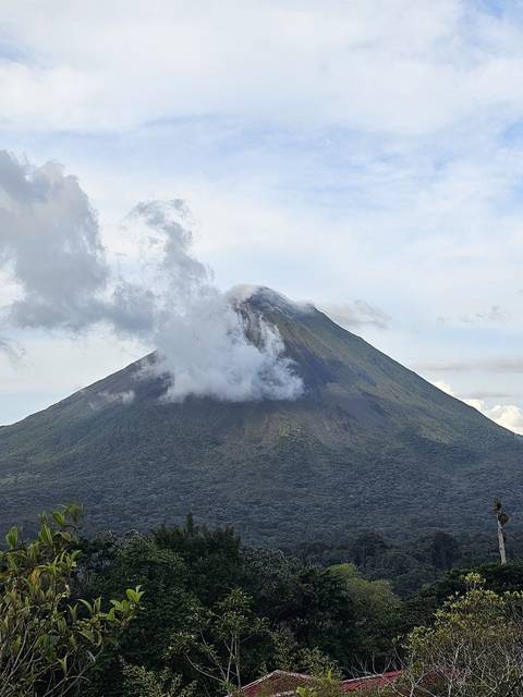 Arenal Volcano in the background with surrounding landscape.