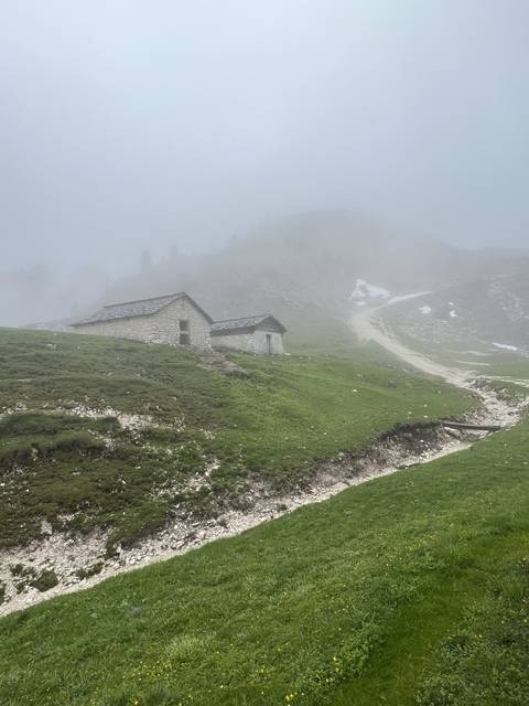 Stone building on a misty hillside, suggesting a foggy day in the mountains.