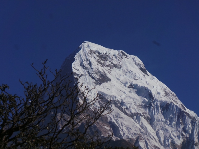       Close-up of a snow-covered mountain with a clear sky.
  