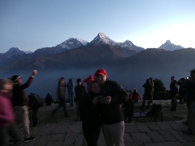       Group of people watching mountains during sunset.
  