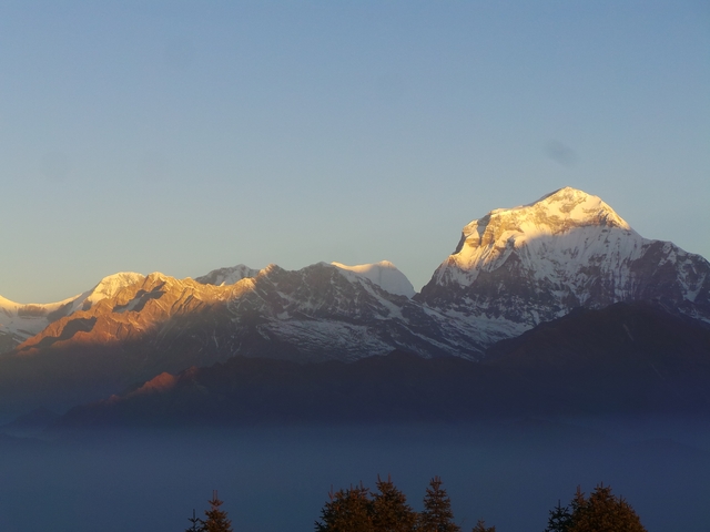       Snow-covered mountains with a clear blue sky.
  
