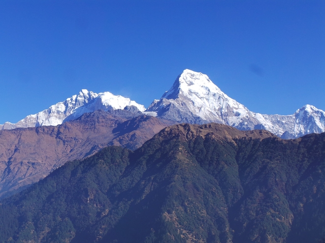       Snow-capped mountain range with clear skies.
  
