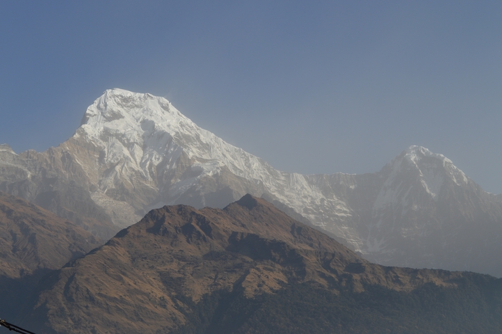       Majestic snow-capped mountain peak under a clear blue sky.
  