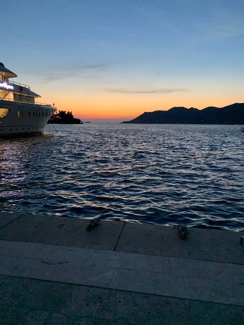 Sunset view over the sea with a distant island.