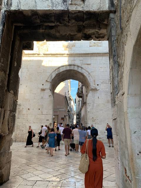 Stone archway with people walking through.