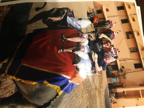 Tourists riding an elephant with a guide