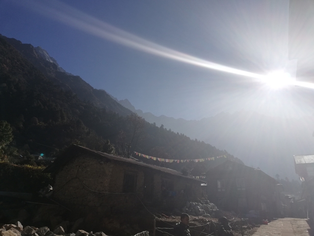 Silhouetted mountains with sun flare.