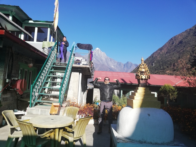 Person posing with mountains in the background.