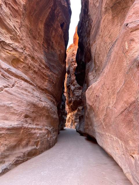       Narrow path between towering rock formations.
  