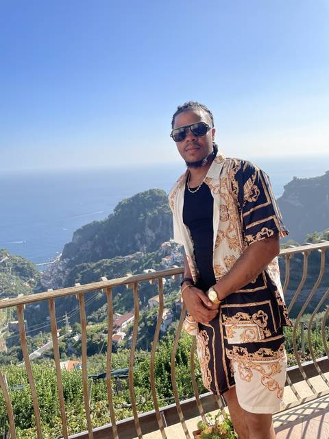 Person posing with a scenic mountain view.