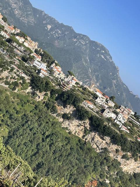 Densely built town along dramatic cliffs.