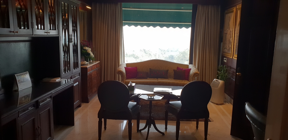       Elegant hotel room with a couch and view of the outdoors.
  