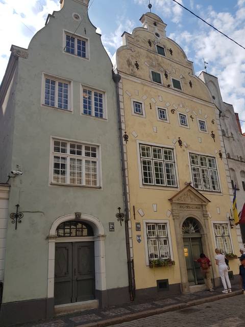       Two colorful historic buildings with decorative facades.
  