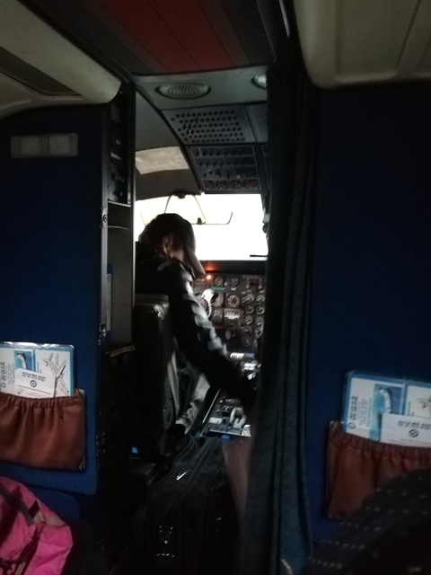 Pilot in an aircraft cockpit preparing for flight.